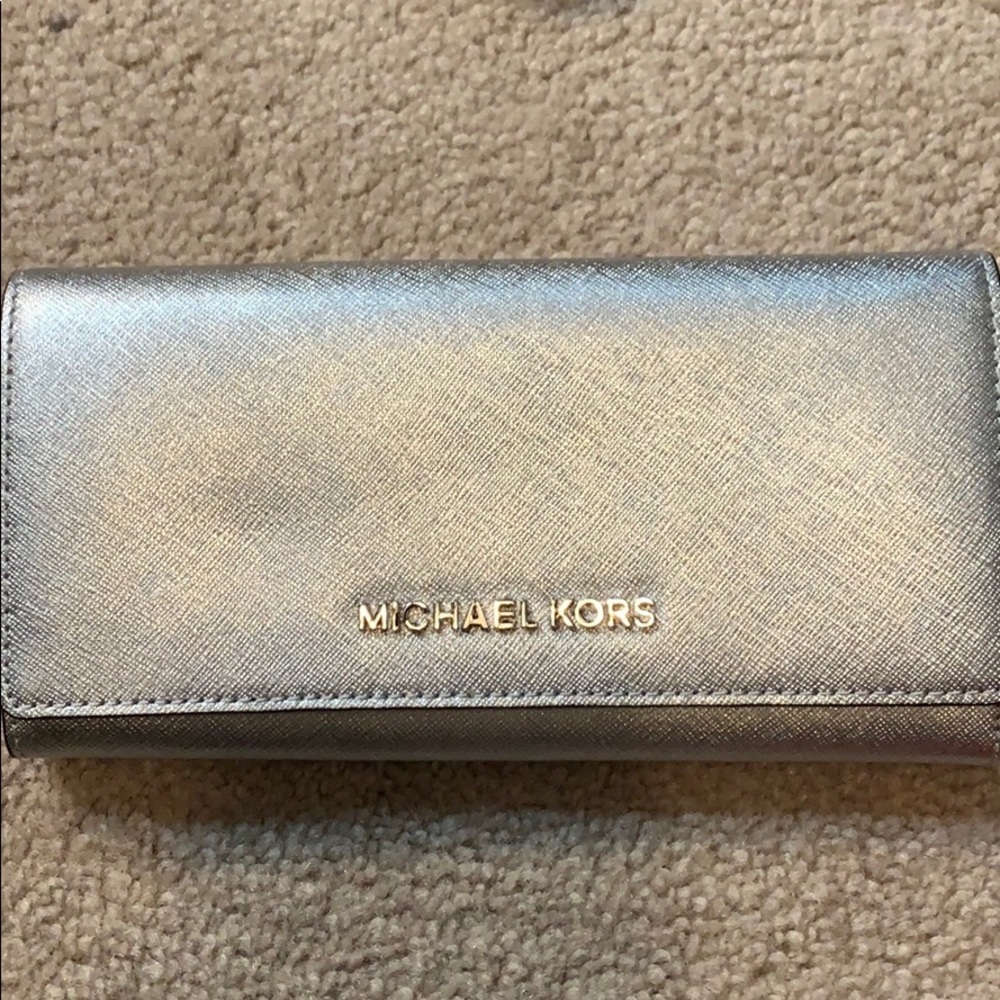 Get glitzy w this silver wallet from MK!